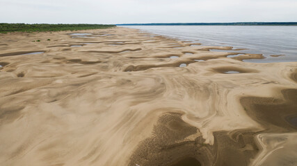 Beautiful sandy river bottom at low tide in northern Siberia on a sunny summer day