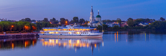 View to St. Catherine monastery with cruise ship on Volga river in summer evening. Beautiful night...