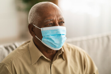 Sick Mature Patient Man Wearing Face Mask Looking Aside Indoors