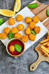 Crispy  deep fried   chicken  nuggets . Breaded  with Cornflakes Breast fillets  with chilly peppers and fresh   basil on wooden rustic background