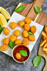 Crispy  deep fried   chicken  nuggets . Breaded  with Cornflakes Breast fillets  with chilly peppers and fresh   basil on wooden rustic background