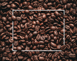 Blank white frame in the roasted coffee beans background, texture with copy space