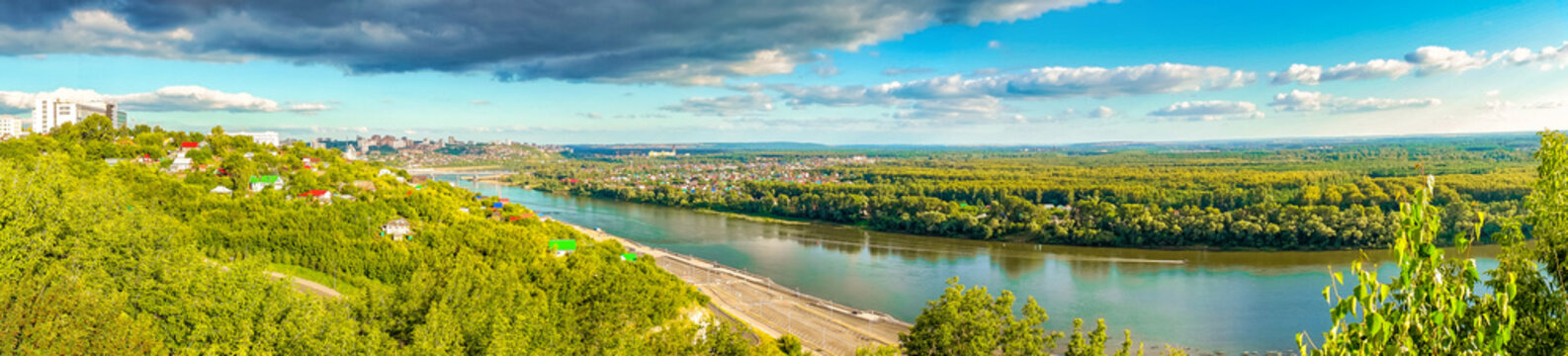 View from observation deck to residential districts of Ufa and Belaya river in summer evening at sunset. Beautiful cityscape, popular view of Ufa city, capital of Bashkiria