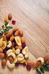 nuts and dried cranberry on the wooden background