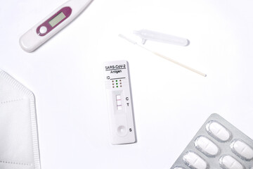 COVID-19 rapid antigen test positive result, thermometer and Paracetamol, immunochromatography of antibodies to detect infections