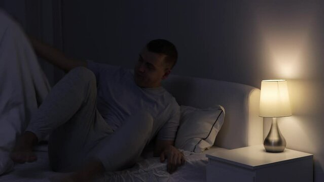 good night - man turns the light off and going to sleep