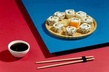 Sushi on a plate on a bright, colored background. 