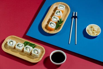 Fish food - sushi, on a bright colored background.