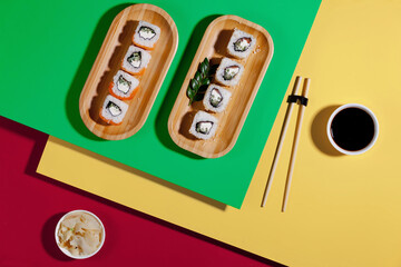 Fototapeta na wymiar Fish food - sushi, on a bright colored background.