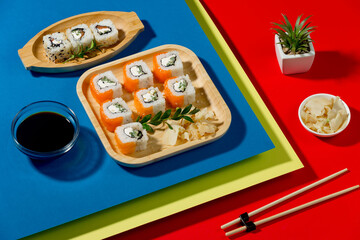 Sushi on a plate on a bright, colored background.