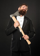 Bearded man scraping chin with axe dark background, barbering