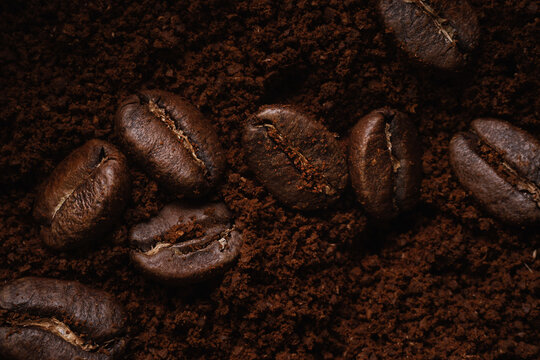 Macrophotography. mixture of coffee beans and ground coffee. view from above. Promotional backdrop of fresh roasted coffee. Raw materials of new harvest for fragrant invigorating drink. © SerPak