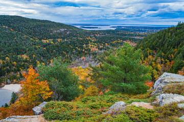 Autumn view from Beech Mountain of the Maine coast along the Atlantic ocean with the beech at Echo lake below 
