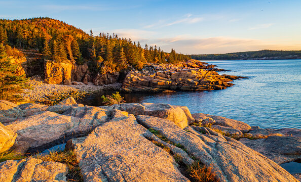early morning sun lights up Monument Beach on the coast of Acadia National Park, Maine, USA
