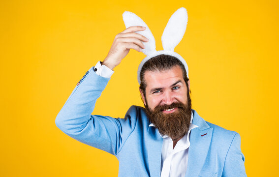 Man in rabbit ears. Preparation for Easter. concept of egg hunt. Easter celebration concept. Man in bunny ears. rabbit man wear hare ears. bunny hunt begins. happy hipster with beard. spring holiday