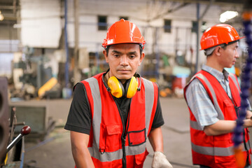 Industrial Engineers in Hard Hats.Work at the Heavy Industry Manufacturing Factory.industrial worker indoors in factory. man working in an industrial factory.