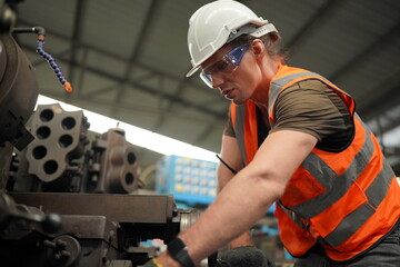 Industrial Engineers in Hard Hats.Work at the Heavy Industry Manufacturing Factory.industrial worker indoors in factory. man working in an industrial factory.