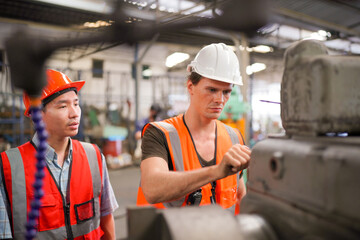 Industrial Engineers in Hard Hats.Work at the Heavy Industry Manufacturing Factory.industrial worker indoors in factory. man working in an industrial factory.