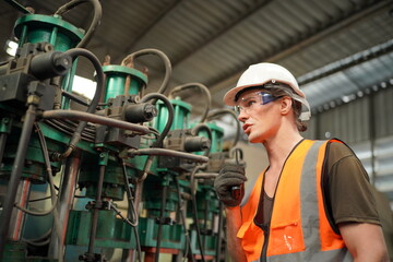 Industrial Engineers in Hard Hats.Work at the Heavy Industry Manufacturing Factory.industrial worker indoors in factory. man working in an industrial factory.