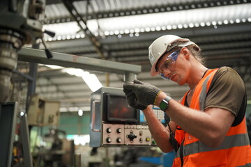 Industrial Engineers in Hard Hats.Work at the Heavy Industry Manufacturing Factory.industrial worker indoors in factory. man working in an industrial factory.