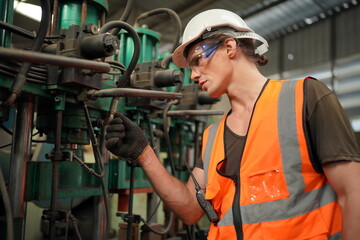 Industrial Engineers in Hard Hats.Work at the Heavy Industry Manufacturing Factory.industrial worker indoors in factory. man working in an industrial factory.