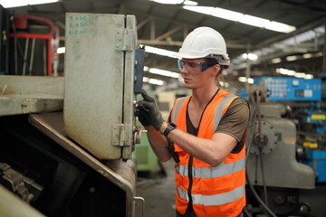 Industrial Engineers in Hard Hats.Work at the Heavy Industry Manufacturing Factory.industrial worker indoors in factory. man working in an industrial factory.