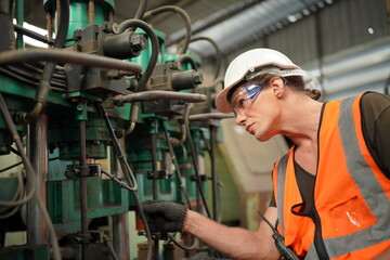 Industrial Engineers in Hard Hats.Work at the Heavy Industry Manufacturing Factory.industrial worker indoors in factory. man working in an industrial factory.
