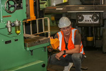 Fototapeta premium Industrial Engineers in Hard Hats.Work at the Heavy Industry Manufacturing Factory.industrial worker indoors in factory. man working in an industrial factory.