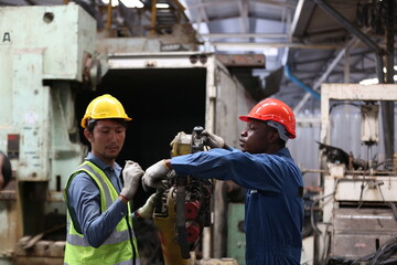 Industrial Engineers in Hard Hats.Work at the Heavy Industry Manufacturing Factory.industrial worker indoors in factory. man working in an industrial factory.