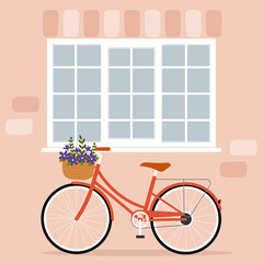 Bicycle with basket of flowers under the window.