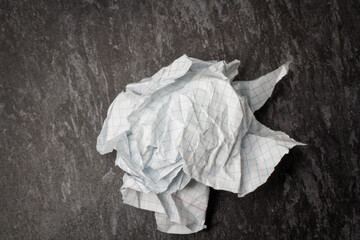 Crumpled and torn paper on the table. Notepad on crumpled paper background.