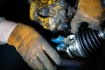 installation of the CV joint on the drive of the car, tightening the clamp on the rubber boot.