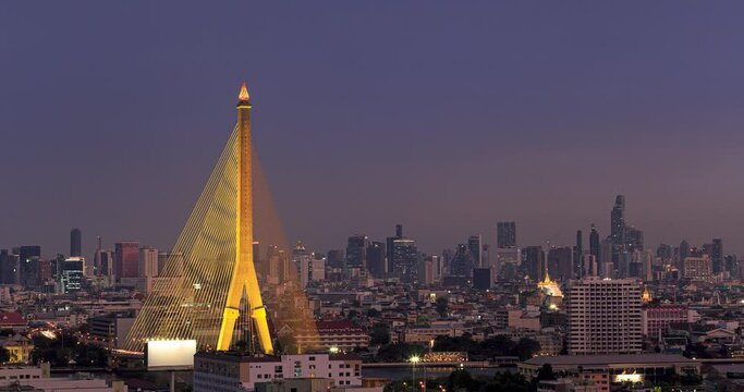 Day to night time-lapse of Rama VIII Bridge with Bangkok skycrapers at sunset, Bangkok, Thailand