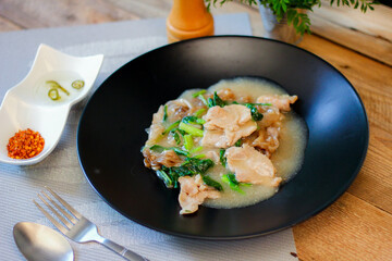 Wide Rice Noodles with pork in Gravy Sauce in black Plate or what we call 