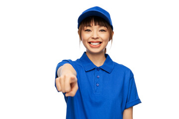 profession, job and people concept - happy smiling delivery woman in blue uniform pointing finger to camera over white background