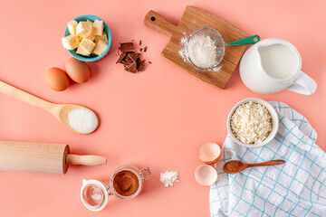 A frame of baking ingredients on a soft pink pastel background. Cooking is flat with a copy space. Top view. Baking concept, layout.