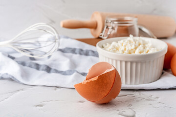 A beautiful composition of baking ingredients with eggs in the foreground.