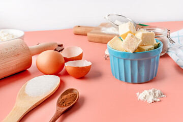 Beautiful baking background. Ingredients for baking: eggs, flour, sugar, butter on a pink background. Space for copying. Banner