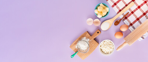 Various products and ingredients for baking at home on a purple background. Copy space, top view.