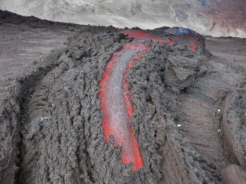 Volcanic river flowing between the solidified lava in Pacaya volcano of Guatemala