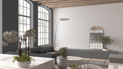 Modern kitchen and living room in vintage apartment in beige and gray tones with windows, flowers close up, depth of fields, sofa. Classic parquet, wooden roof beams, interior design