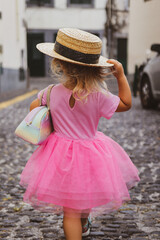 a little girl in a pink princess dress in funchal madeira portugal 