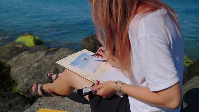 Painting watercolor sea scenes is her hobby