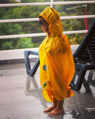 little cute girl is playing in the rain on playground in machico madeira portugal 