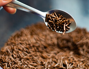 Chocolate sprinkles background ( chocolate granulado ), sweet food, candy. Ingredient used to make brigadeiro cake, pot cake and chocolate sweets. Selective focus, Close up
