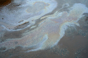 Oil stain on Asphalt, color Gasoline fuel spots on Asphalt Road as Texture or Background