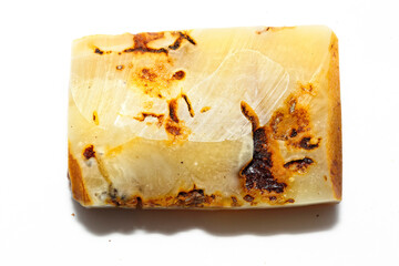 Amber with inclusions on a white background. Patterns in the mineral. Decorations. Sun stone....