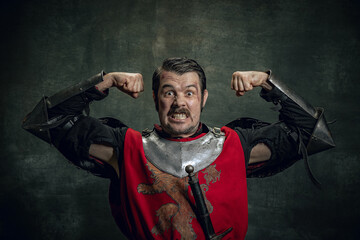 Portrait of brave medieval warrior or knight with dirty wounded face looking at camera isolated...
