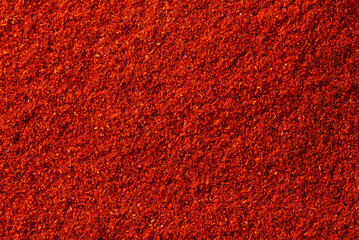 Red smoked paprika background. Top view macro photo with shallow depth of field.