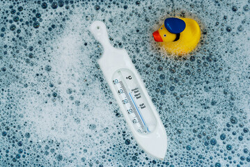 above view of thermometer in baby bath for temberature check